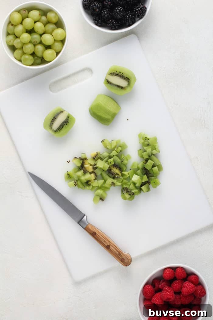 Fresh Fruit Salsa Recipe with Lime and Cilantro 4 Diced kiwi on a white cutting board.