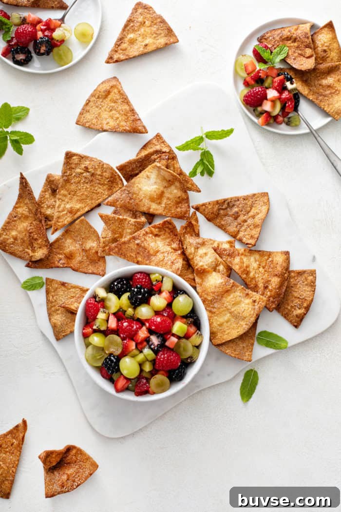 Fresh Fruit Salsa Recipe with Lime and Cilantro 8 Overhead view of a bowl of fruit salsa surrounded by cinnamon chips.
