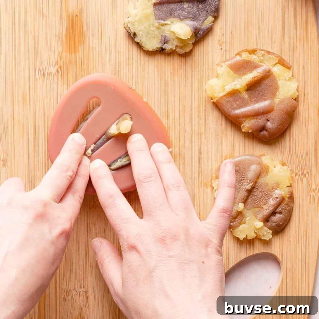 precooked potatoes being smashed with a spatula.