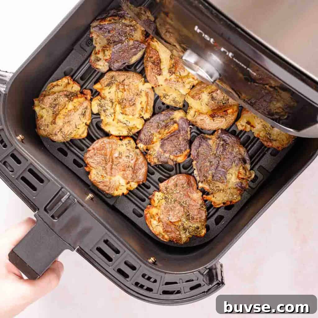 cooked smashed potatoes in air fryer drawer.