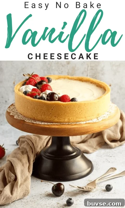 No bake vanilla cheesecake on a cake stand topped with mixed berries, surrounded by a light brown napkin and two forks