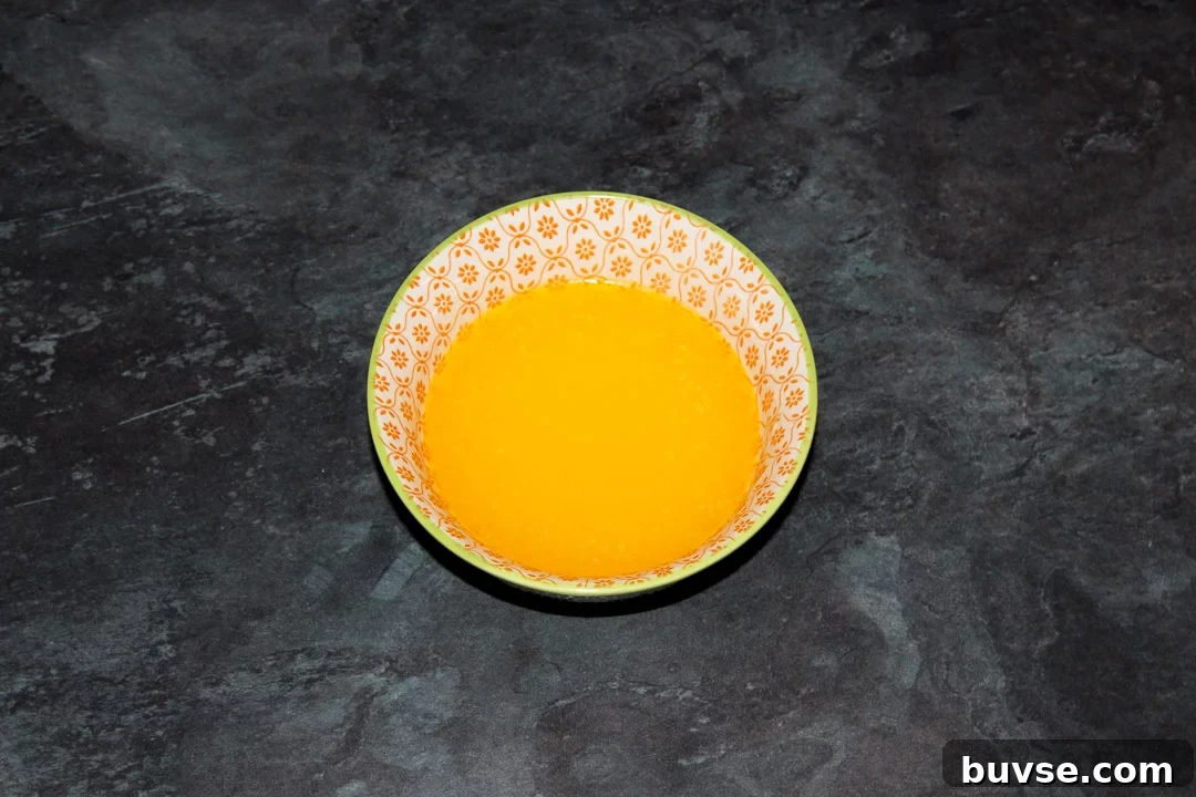 Melted butter in a small bowl.