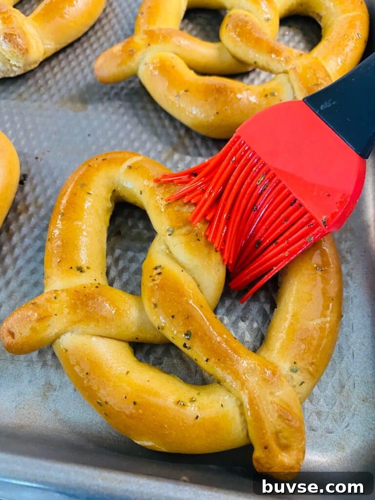 brushing the pretzel with garlic butter
