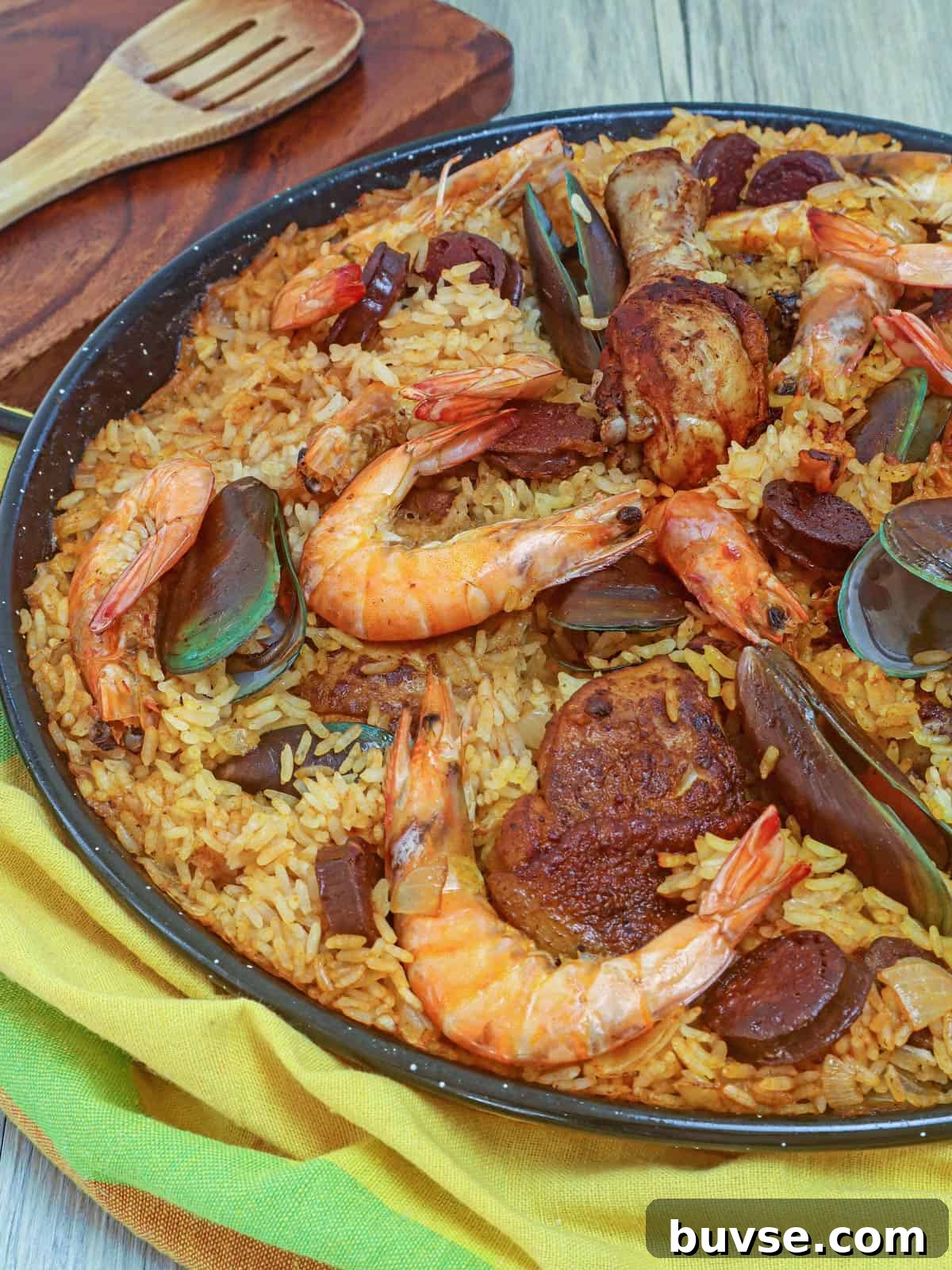 Paella with shrimp, chicken, mussels in a wide pan
