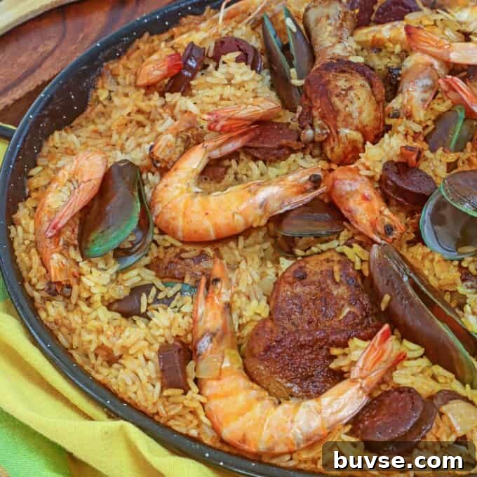 Paella with shrimp, chicken, mussels in a wide pan