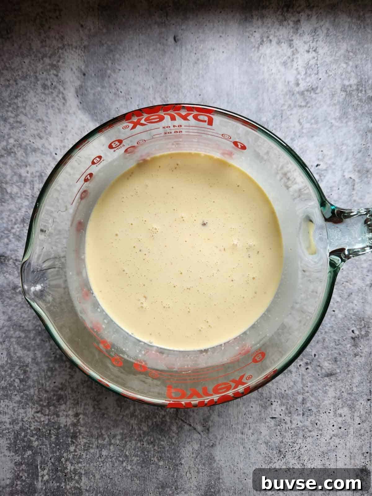 Mixed ice cream batter in a clear bowl.
