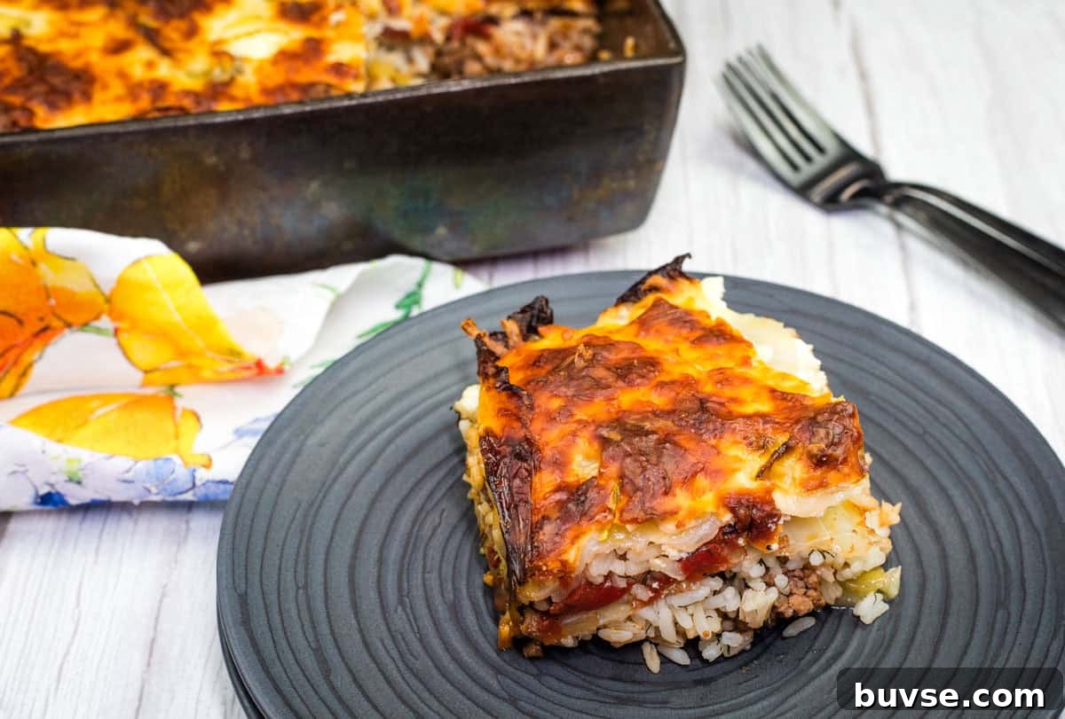 A slice of Beefy cabbage roll casserole on a black plate.