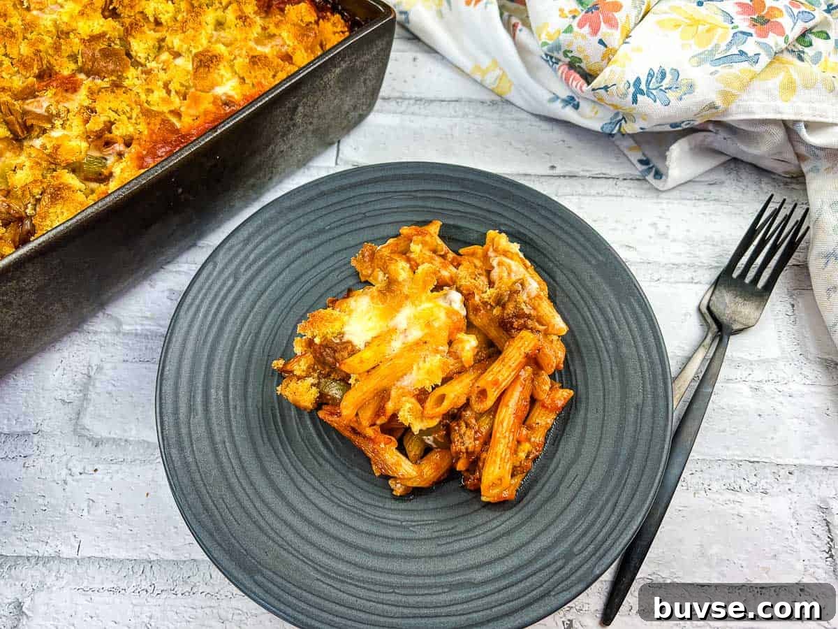 A serving of Sloppy Joe Casserole pasta with meat on a plate with a fork.