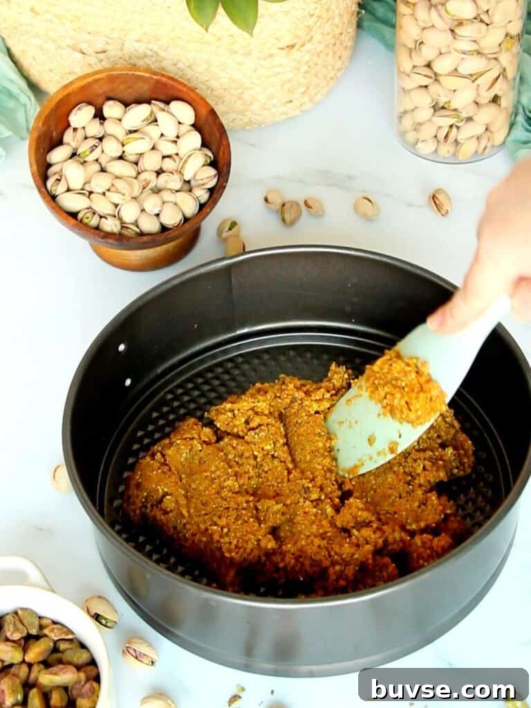 Tapping Graham crumbs into a pan