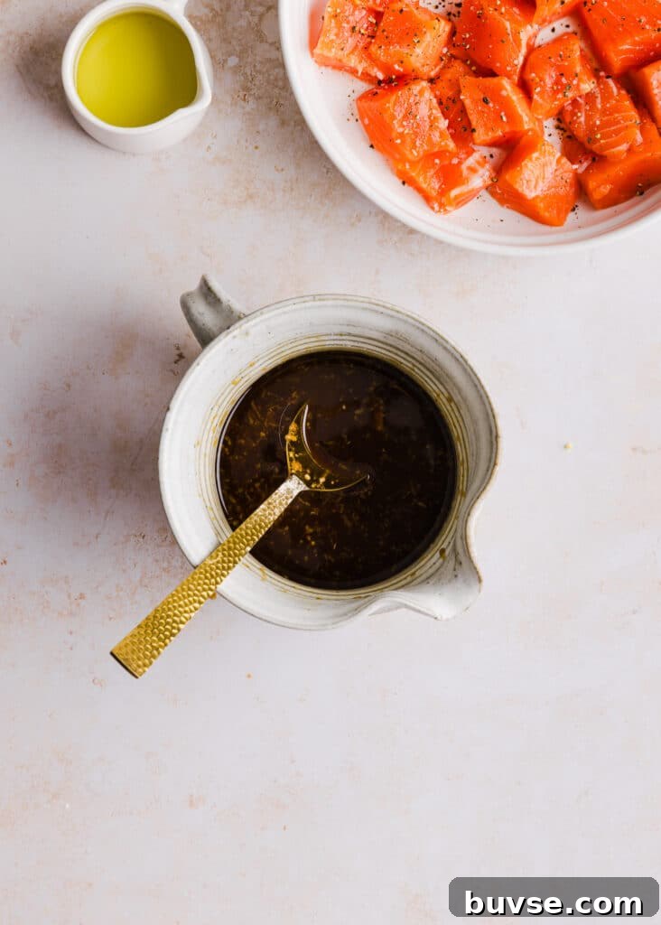 Teriyaki sauce mixed up in a small bowl with a spoon.
