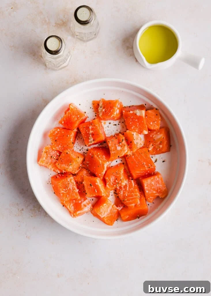 Cut up salmon in a dish with salt and pepper.
