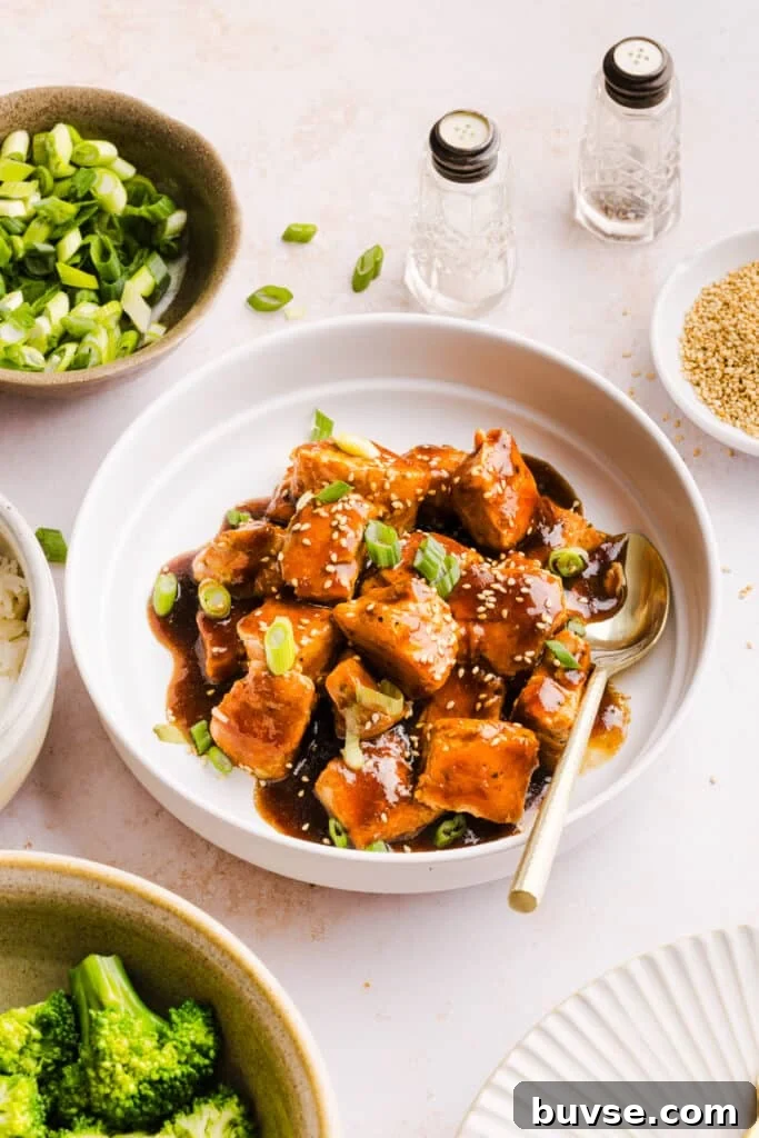 Teriyaki salmon bites in a serving bowl.