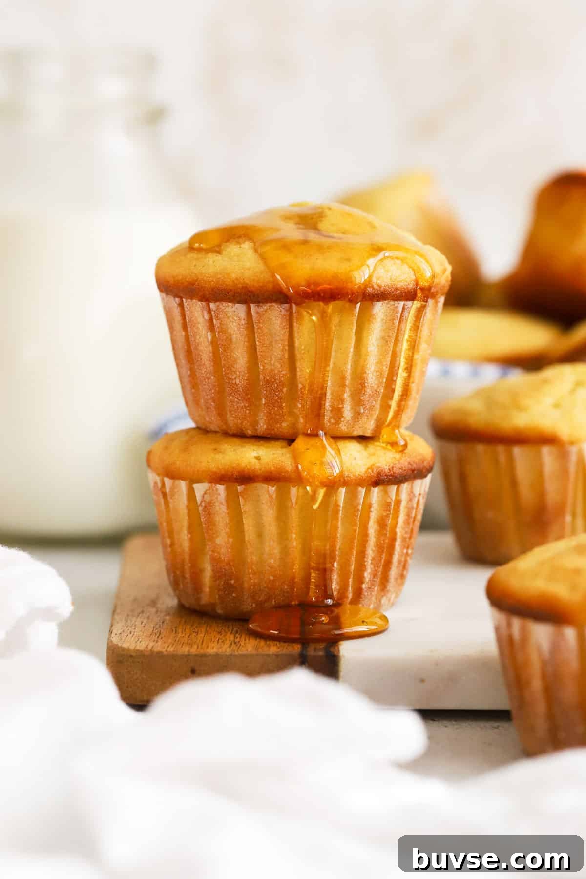 Moist Gluten-Free Corn Muffins with Crispy Tops 2 gluten-free cornbread muffins drizzled with honey