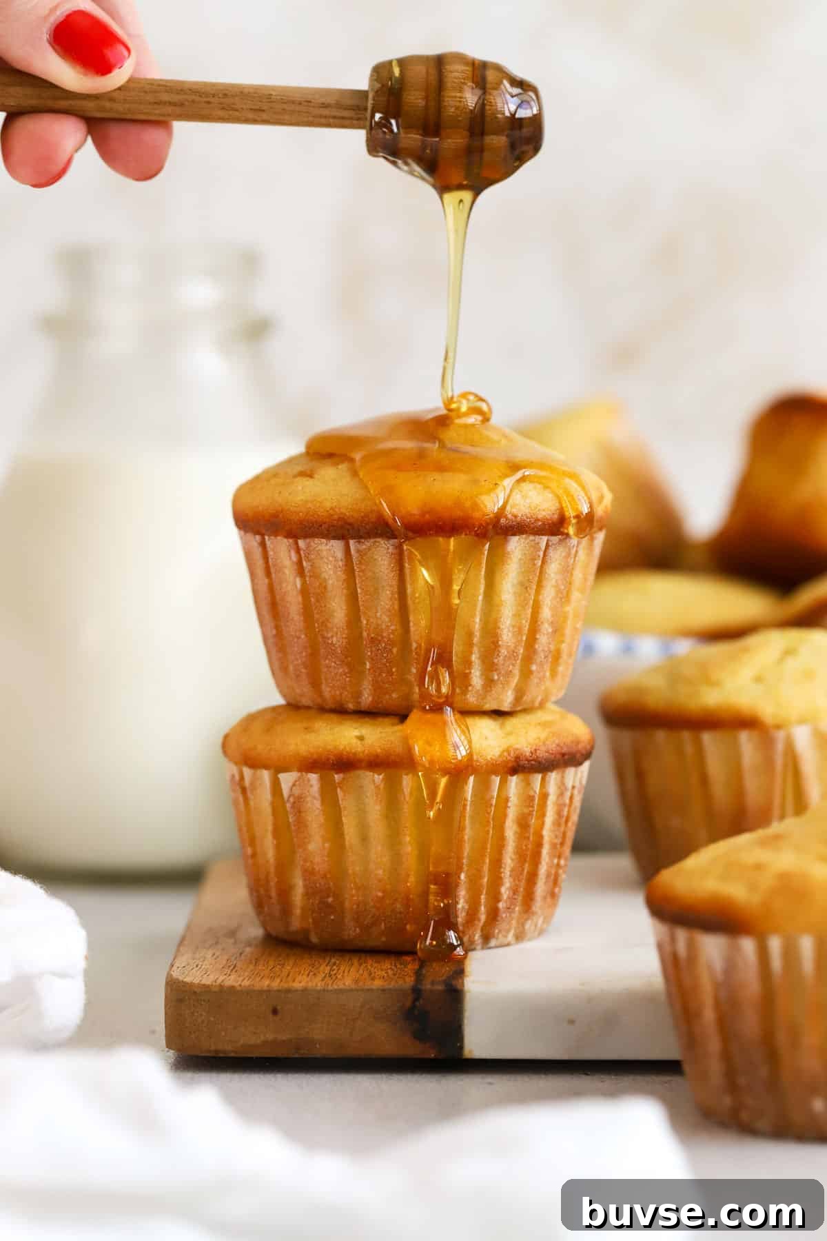 Moist Gluten-Free Corn Muffins with Crispy Tops 5 gluten-free corn muffins drizzled with honey