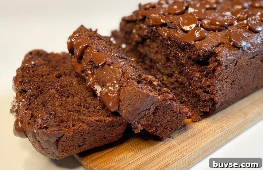 Double Chocolate Zucchini Bread 11 Sliced bread on a wooden cutting board.