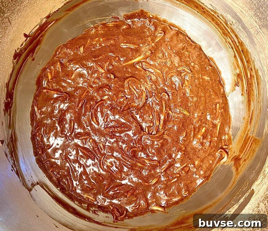 Double Chocolate Zucchini Bread 7 Adding the shredded zucchini to the batter.