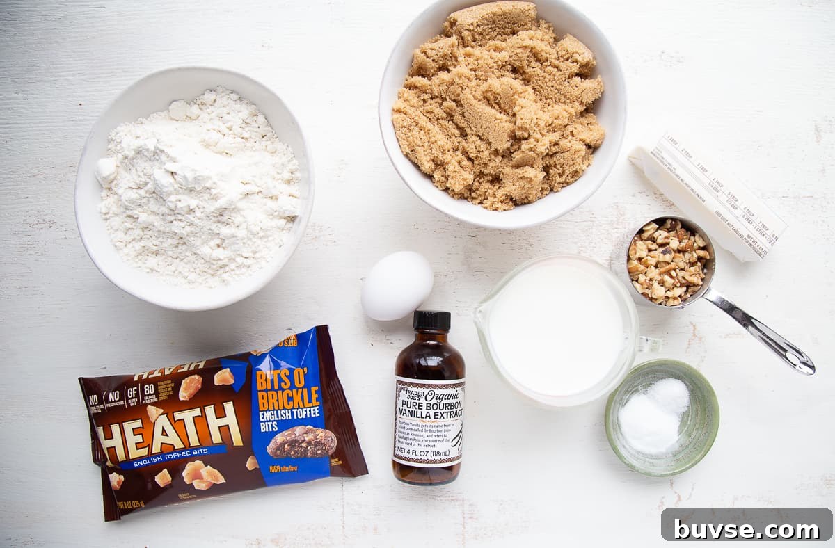 flour, sugar, vanilla, and other baking ingredients on a white table.