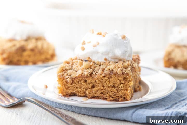 slice of cake topped with heath bar bits and whipped cream.