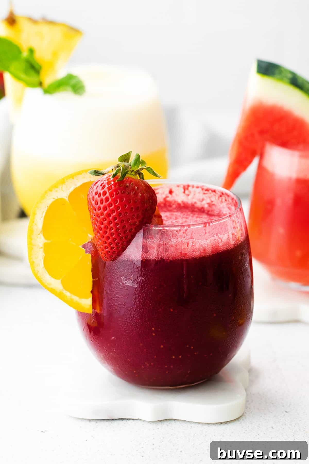 two glasses of watermelon and orange juice.
