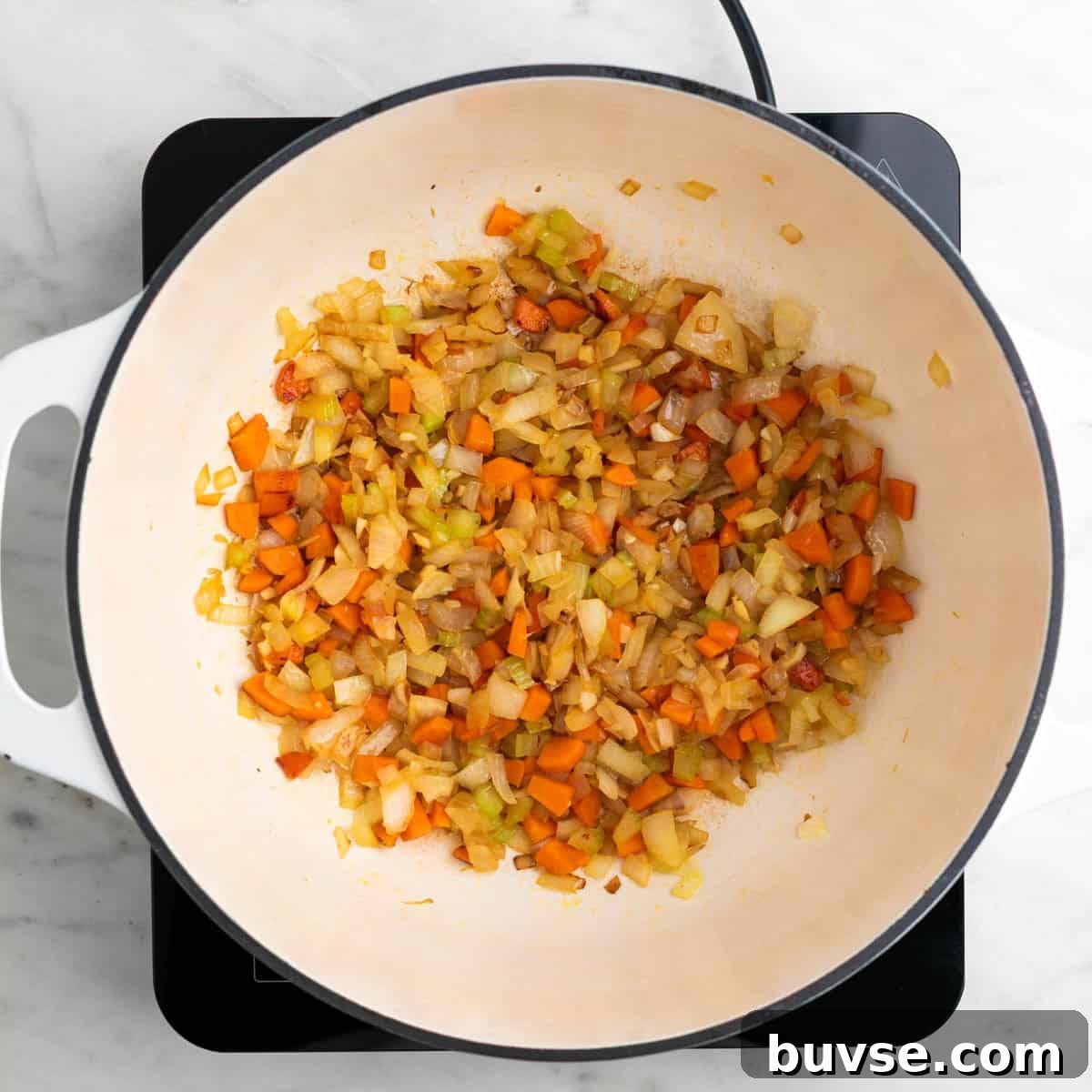 Onion, celery, carrot, and garlic sautéed in a large pot.