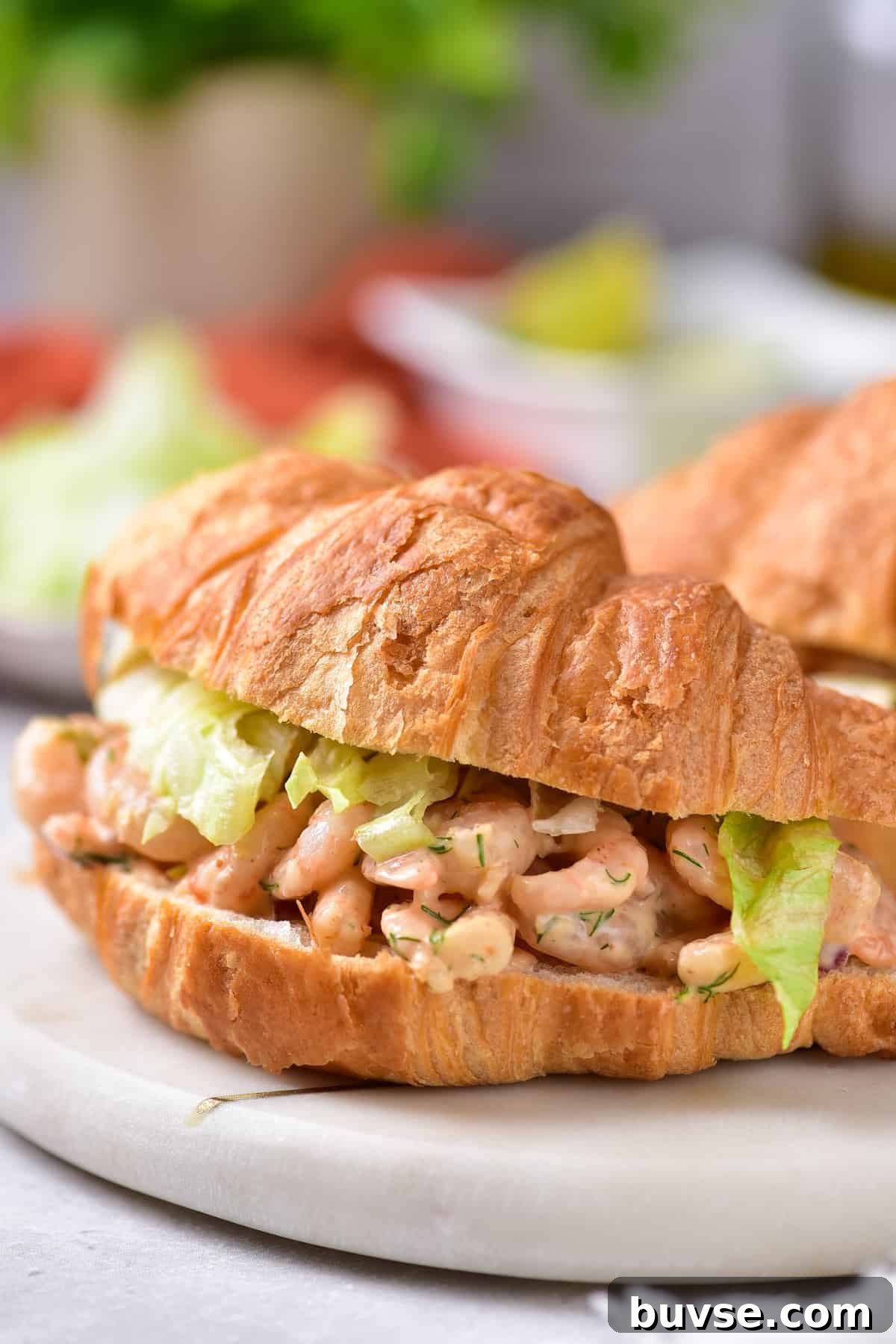 Zesty Old Bay Shrimp Salad Recipe with Lemon and Celery 2 Shrimp salad dressed on a croissant.