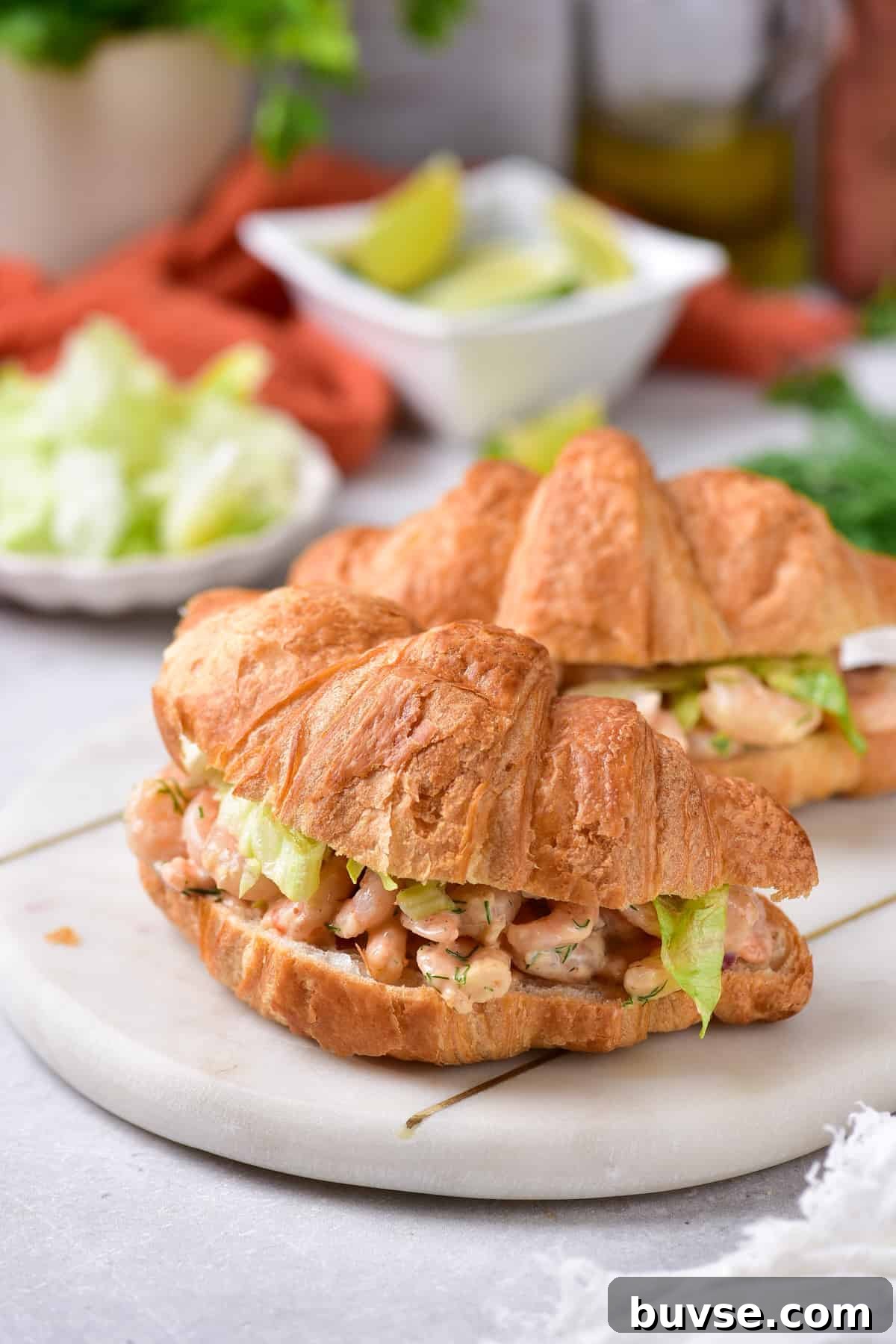 Zesty Old Bay Shrimp Salad Recipe with Lemon and Celery 6 Two shrimp salad sandwiches on a plate.