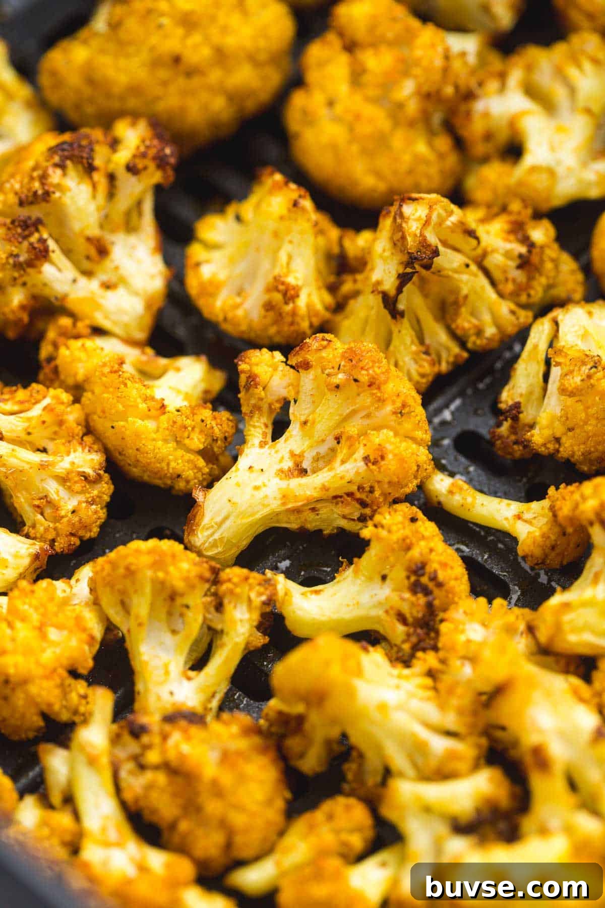 Close up shot of Air fried cauliflower in an air fryer basket
