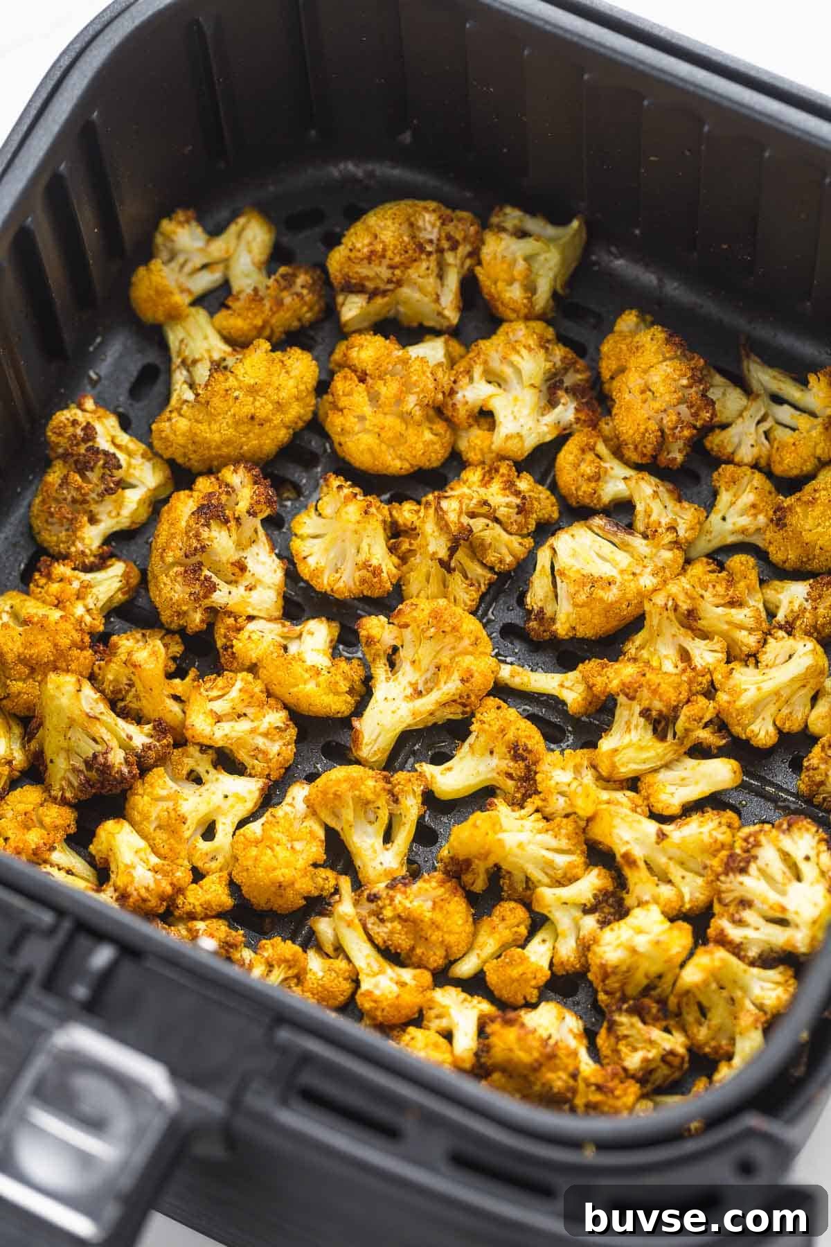 Crispy Air fried cauliflower in an air fryer basket