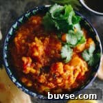 vegetable dal in a decorative bowl with cilantro garnish.