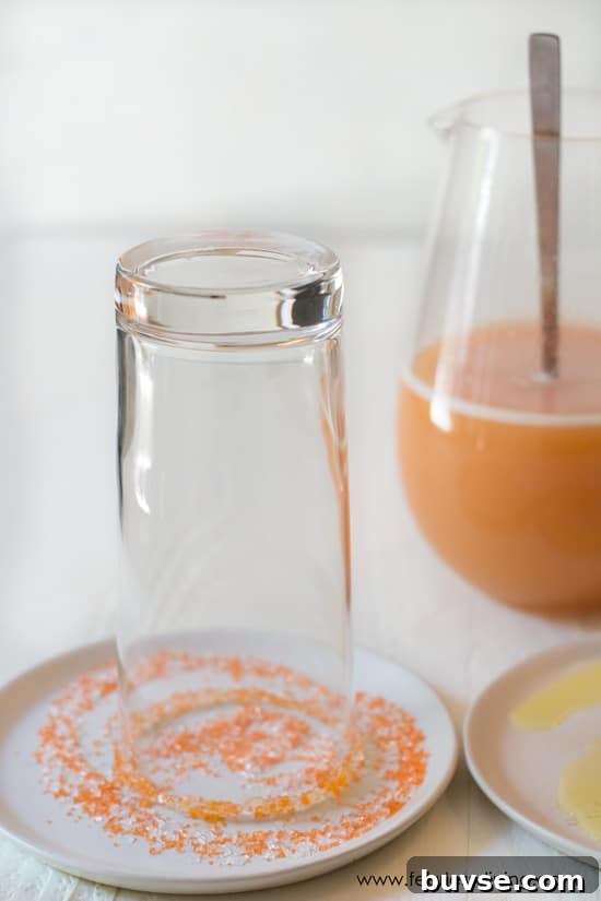 POG Cocktail Recipe: Passion Fruit, Orange and Guava 5 Sugaring the rim of the glass with orange sugar.