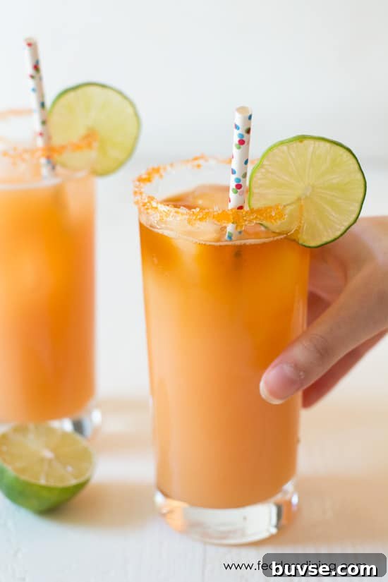 POG Cocktail Recipe: Passion Fruit, Orange and Guava 6 A hand is reaching to grab one of the POG cocktails.