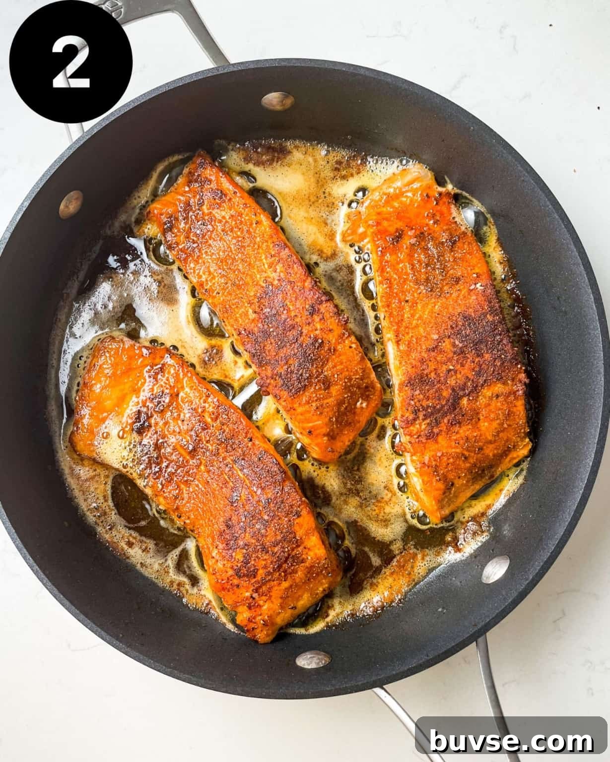 salmon filets in a skillet.