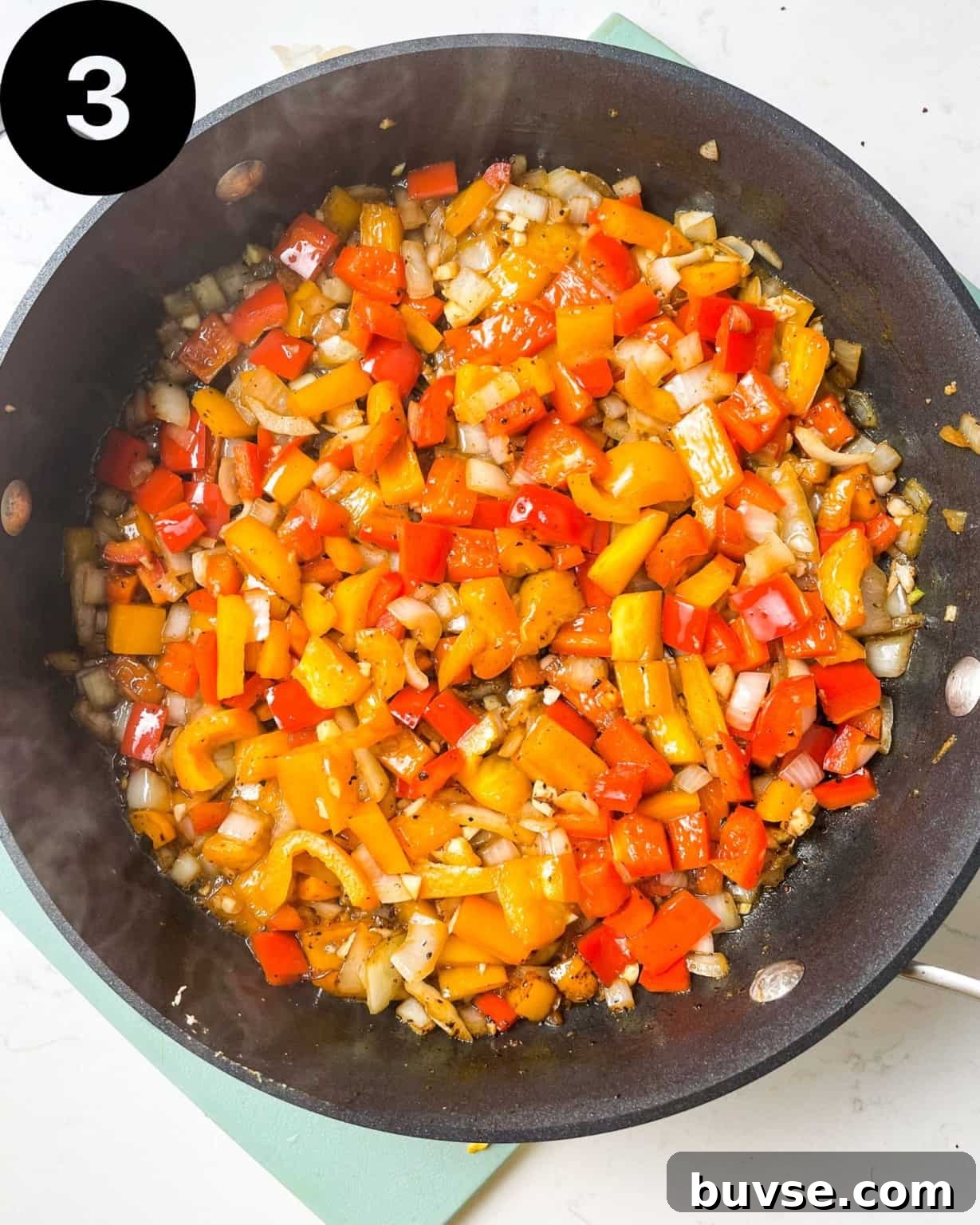 diced onions, bell peppers, and garlic in a skillet.