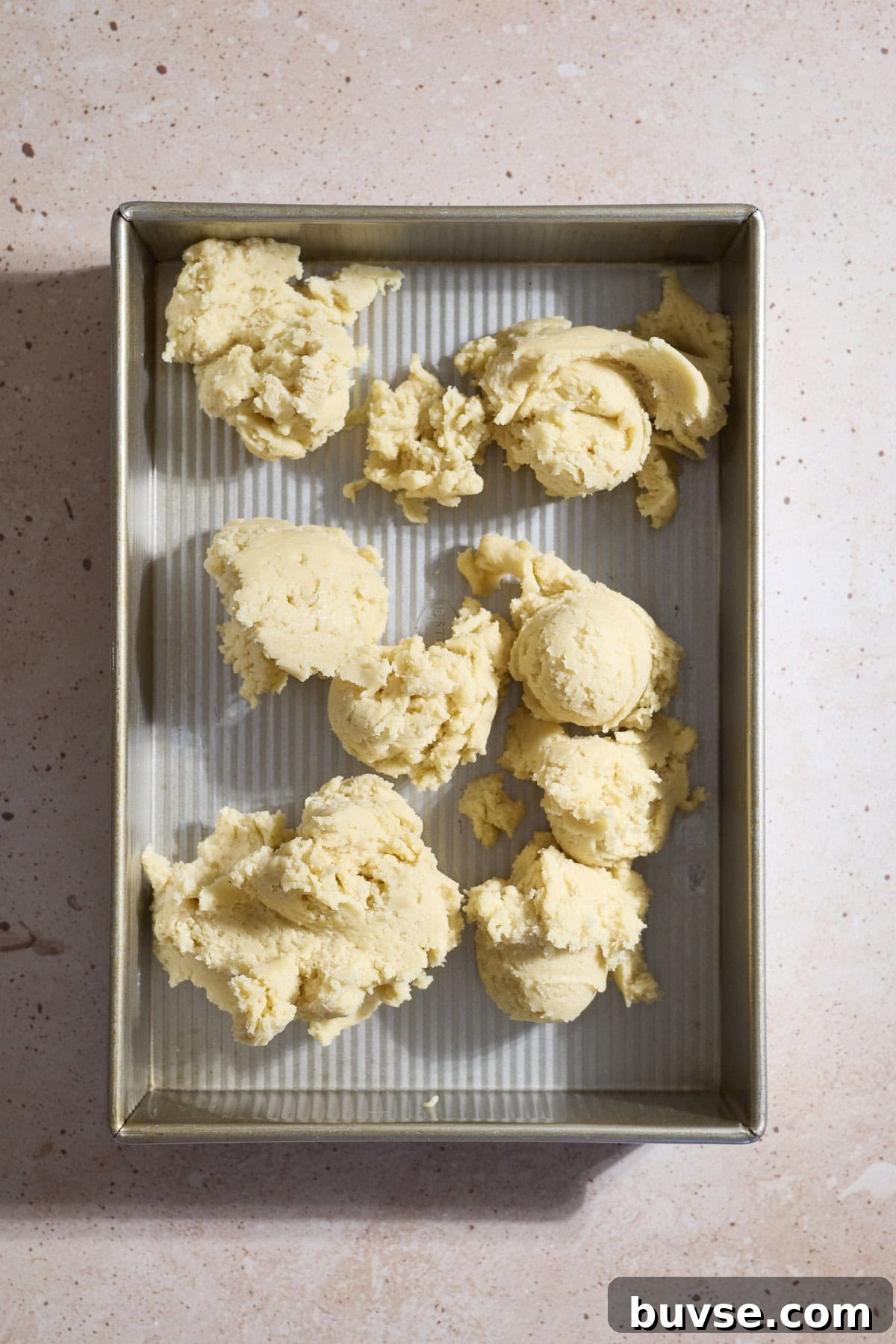 Dough dropped by spoonfuls in a 9x13-inch baking pan.