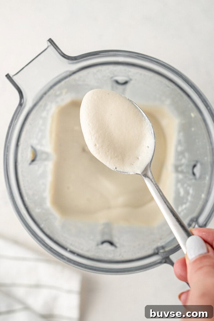 Flavorful Dairy-Free Chicken Enchiladas Recipe 6 The creamy blended cashew cheese sauce in the blender.