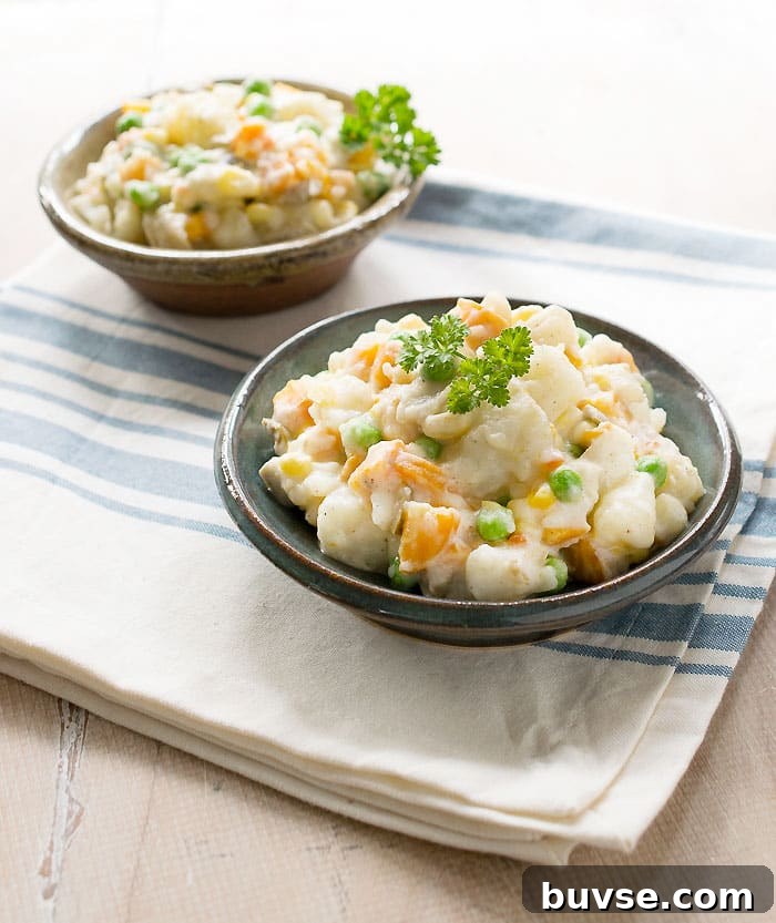 2 Potato Salad in small bowls on white cloth with blue stripes