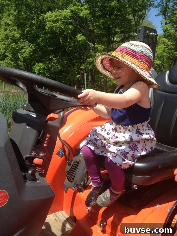 Child pretending to work on farm tractor