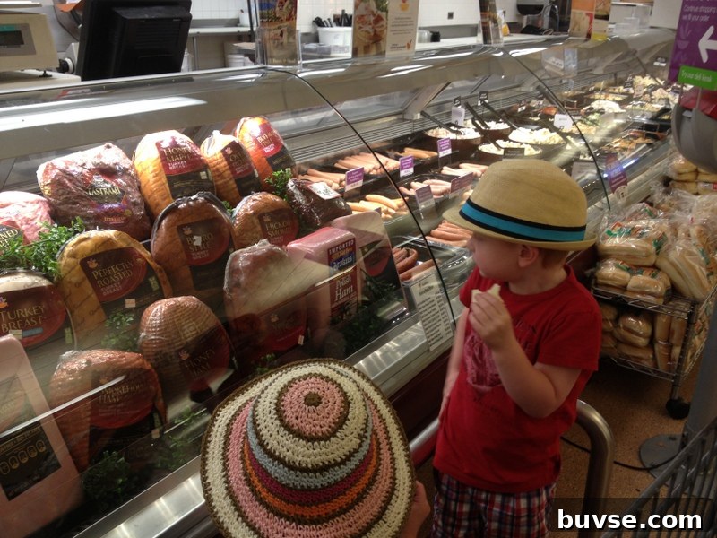 Children with deli counter full of cheese