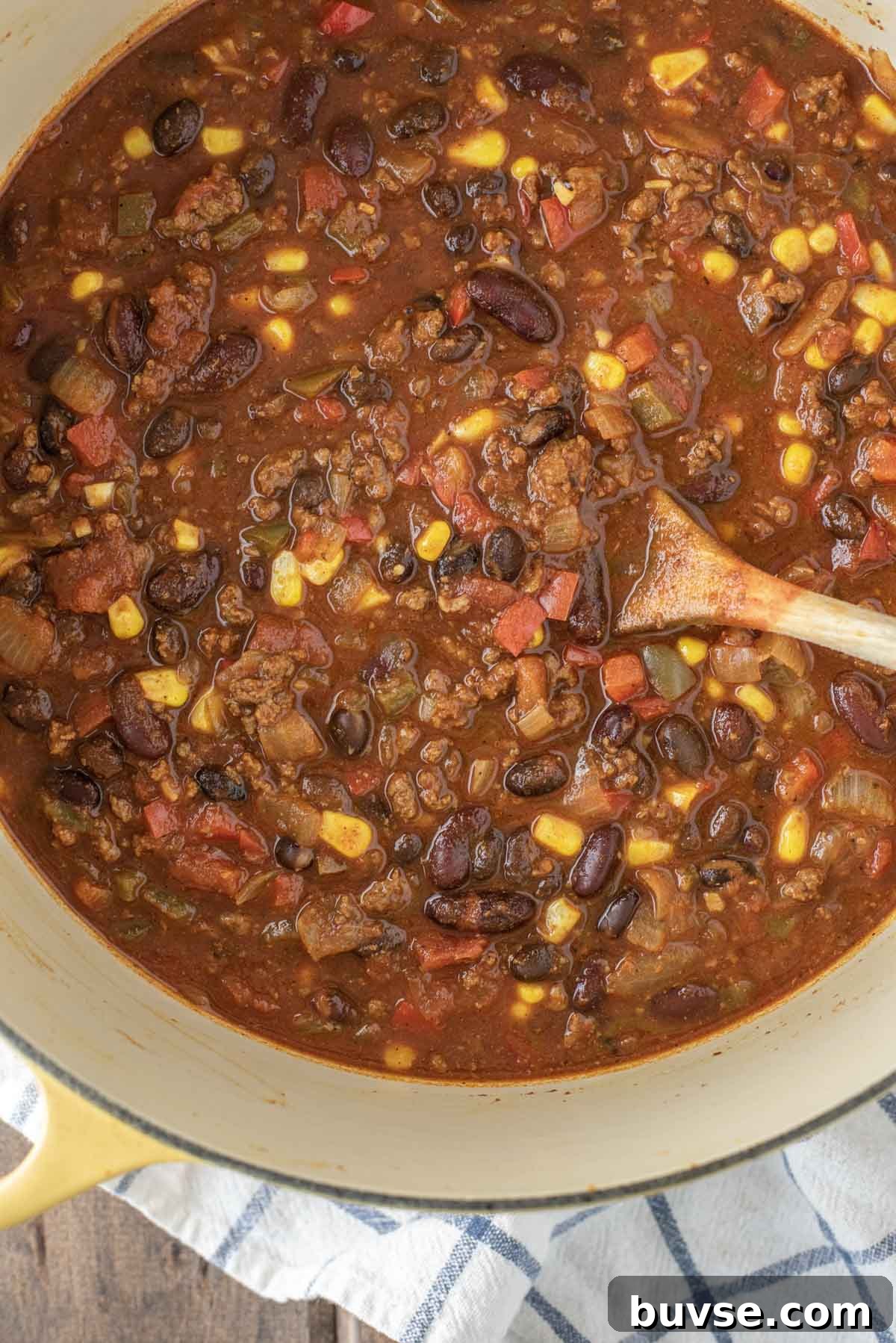 overhead shot of beef chili in yellow Dutch oven