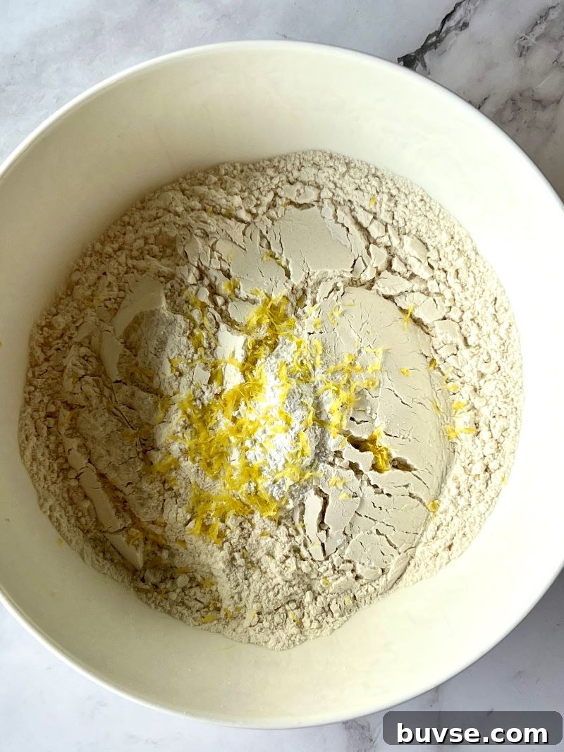 Dry ingredients mixed in a medium bowl with lemon zest.