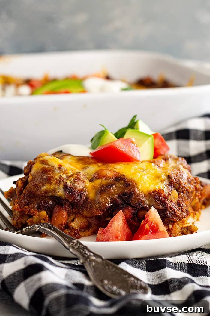 Pantry Recipes: Creative Shelf Cooking with Staples 11 A slice of Mexican Casserole on a white plate with a fork.
