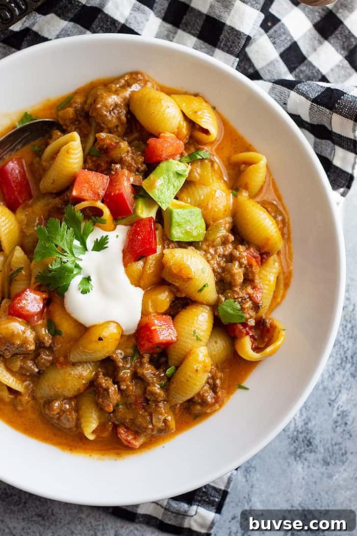 Pantry Recipes: Creative Shelf Cooking with Staples 14 top down picture of a bowl of taco pasta topped with taco toppings.