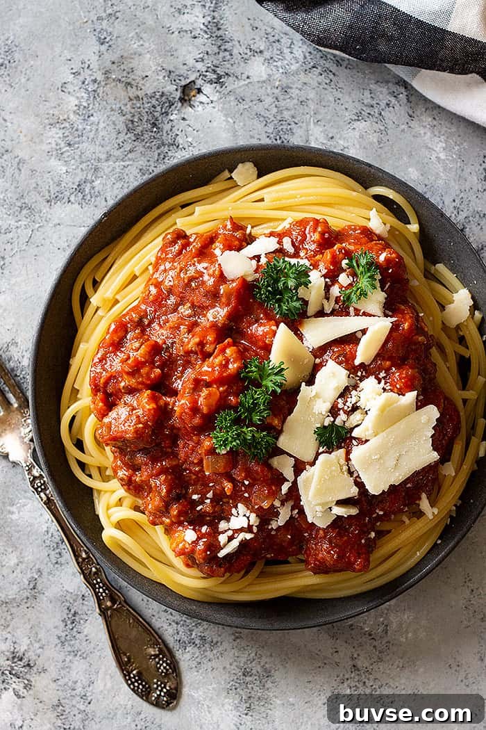 Pantry Recipes: Creative Shelf Cooking with Staples 34 Top down view of spaghetti sauce over noodles and topped with cheese.