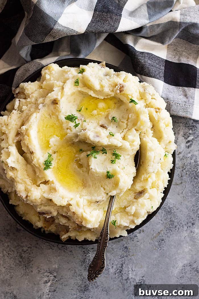 Pantry Recipes: Creative Shelf Cooking with Staples 46 Large bowl of slow cooker mashed potatoes with pools of melted butter and chopped parsley for garnish.