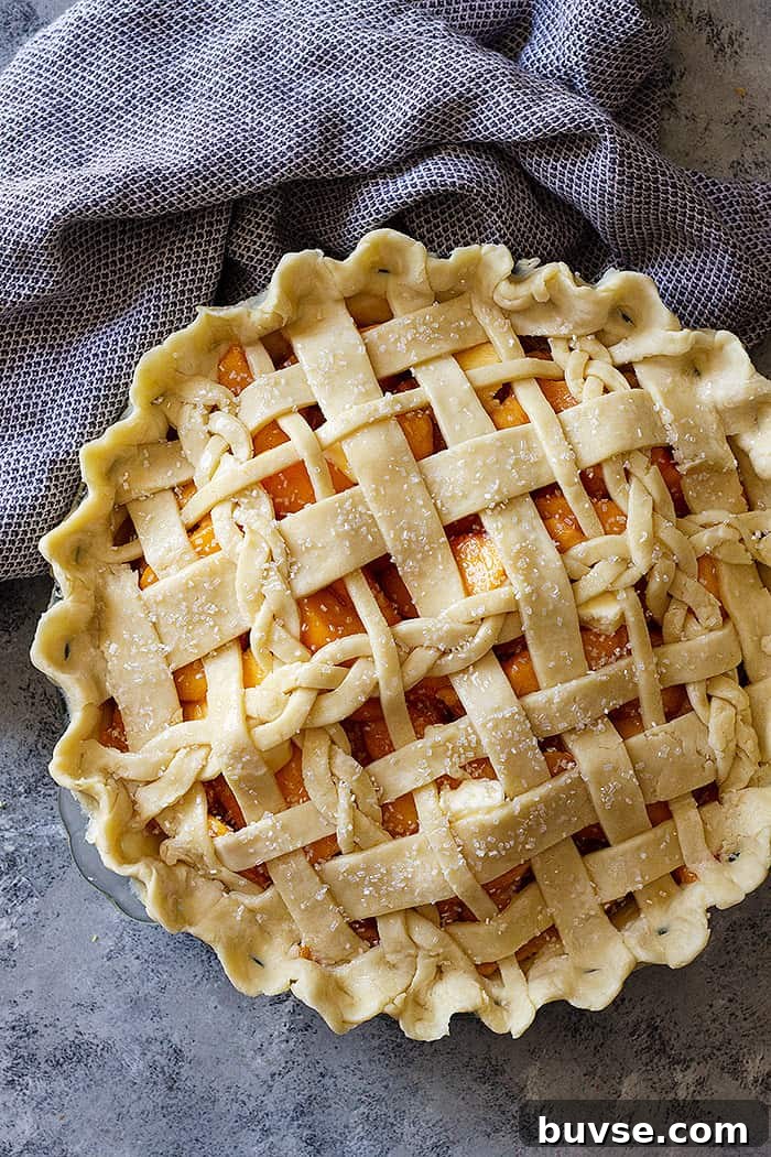 Pantry Recipes: Creative Shelf Cooking with Staples 64 Top down view of a peach pie with an all butter crust lattice top.