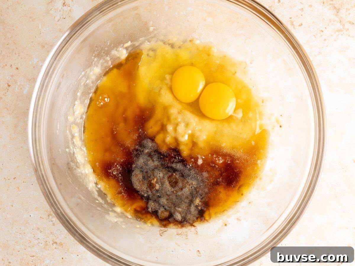 One-Bowl Brown Butter Mochi Banana Bread Recipe 6 Wet ingredients in a glass mixing bowl.