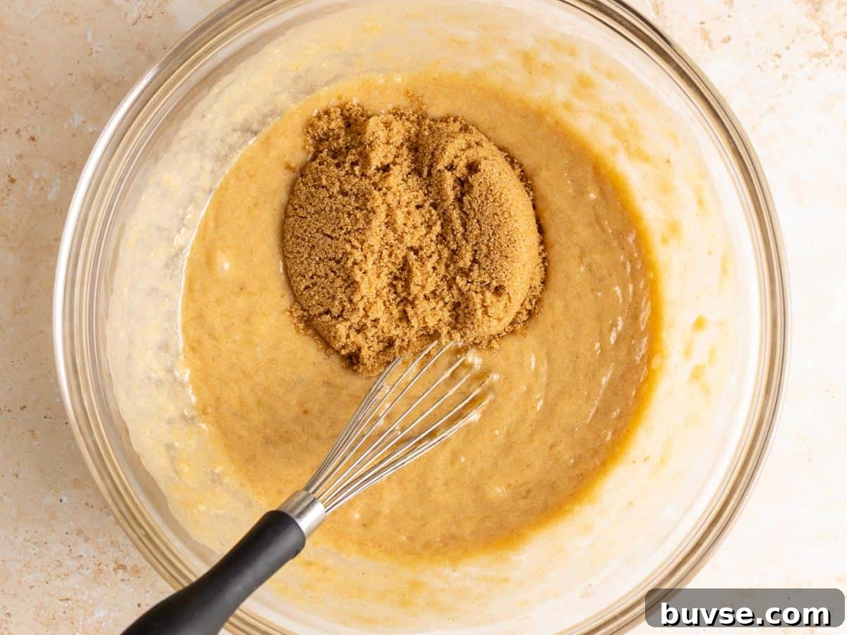 One-Bowl Brown Butter Mochi Banana Bread Recipe 7 Brown sugar in a bowl with wet ingredients.