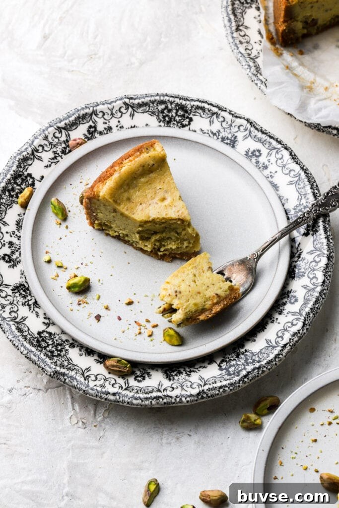plate with pistachio cheesecake a bite taken out