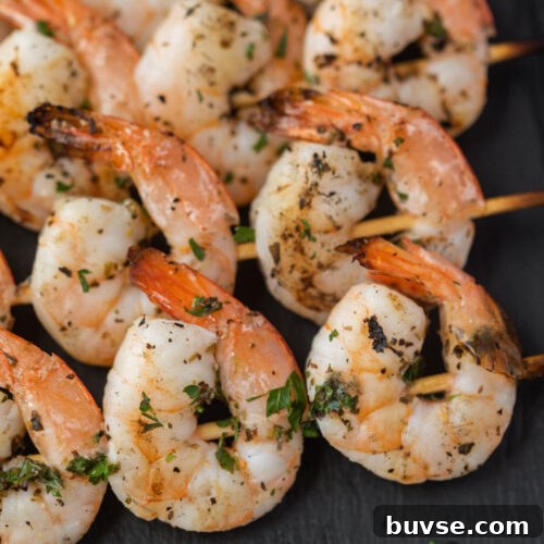 Leftover Shrimp Recipes: 12 Flavorful Ideas 32 Grilled shrimp on skewers with herbs.