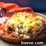 square image of slice of cattle drive casserole on clay plate